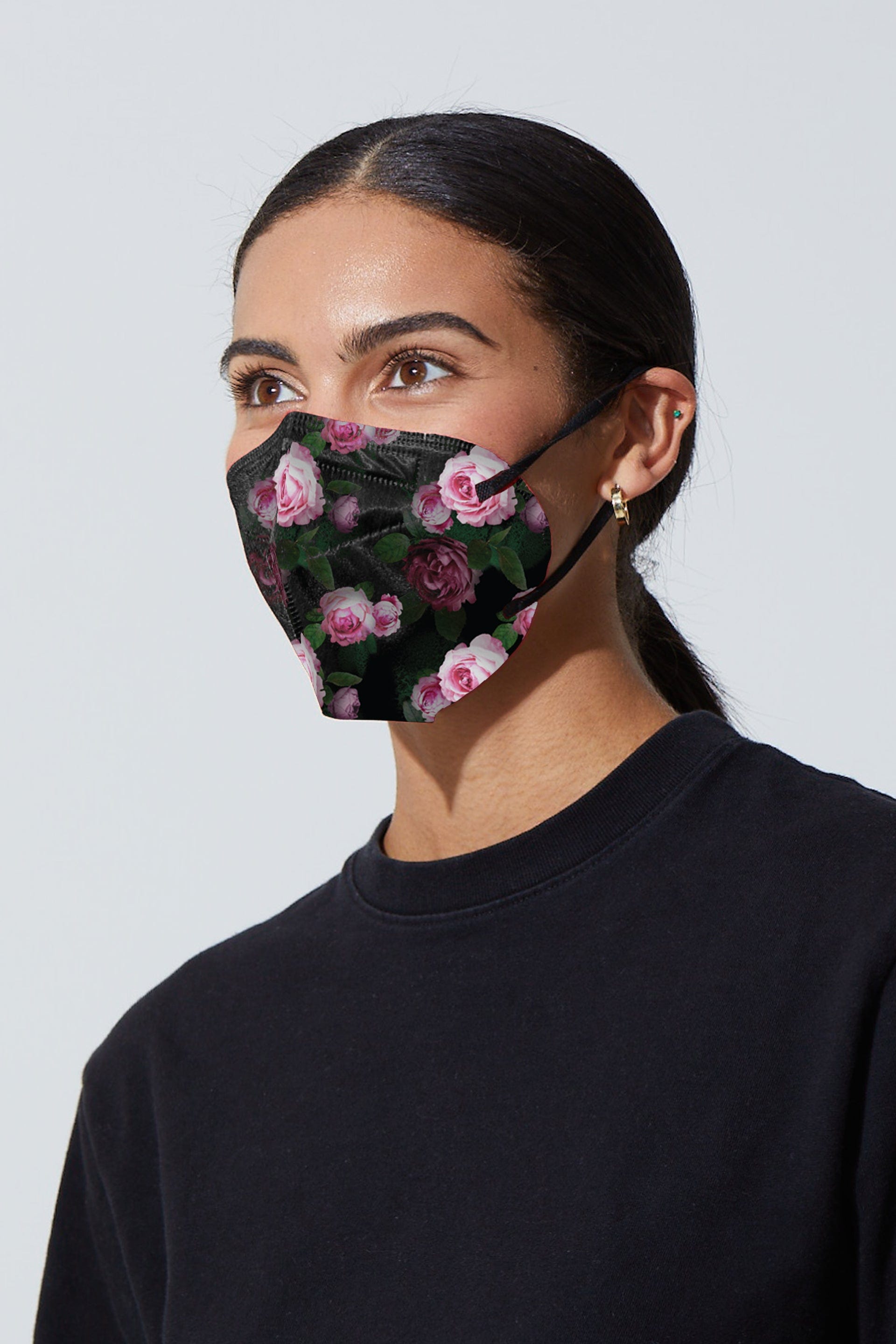 Woman wearing stylish rose printed KN95 face mask, with high quality breathable fabric. 